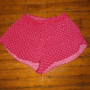 red flowy shorts with pink floral print